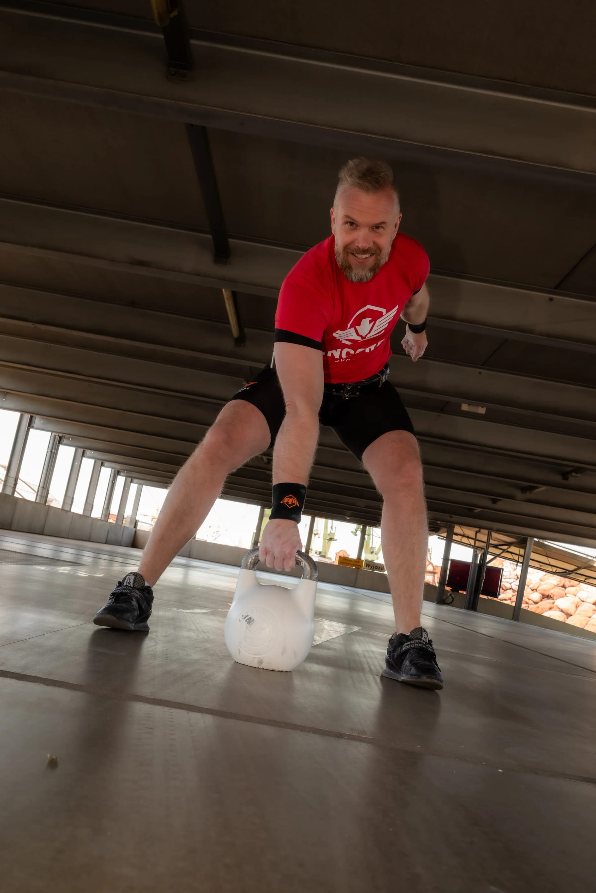 Athlete preparing for a kettlebell swing with an Incore Sports hardstyle bell